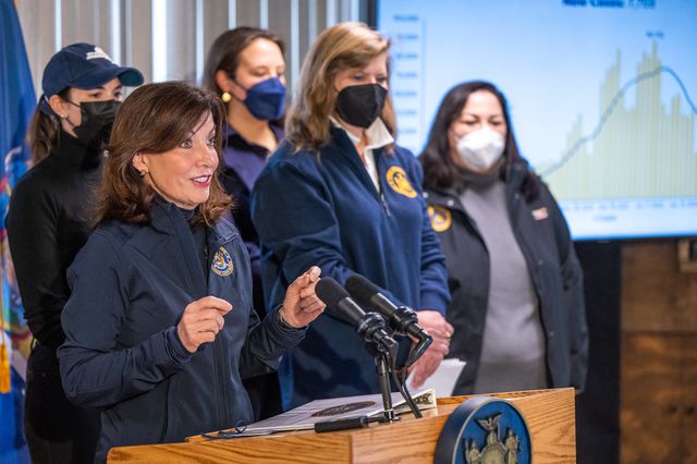 Governor Hochul at a briefing, she is not wearing a mask but her officials are
